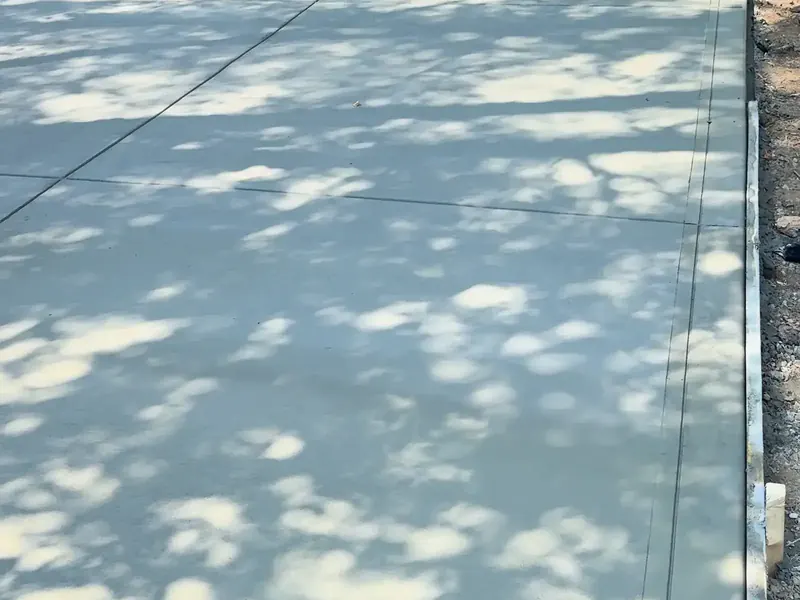 New concrete driveway in dappled shade in Charlotte