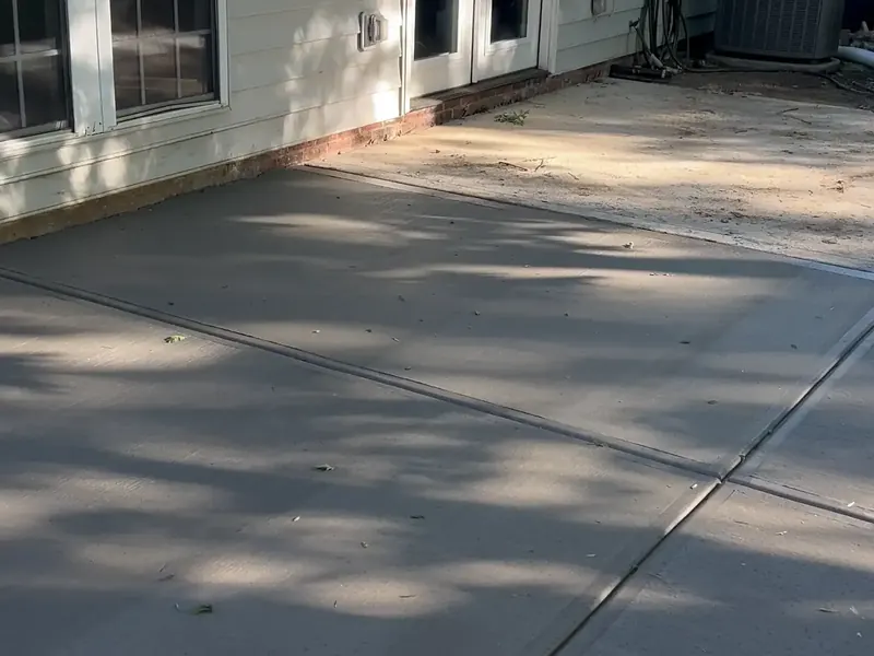 Backyard concrete patio beside French doors in Charlotte