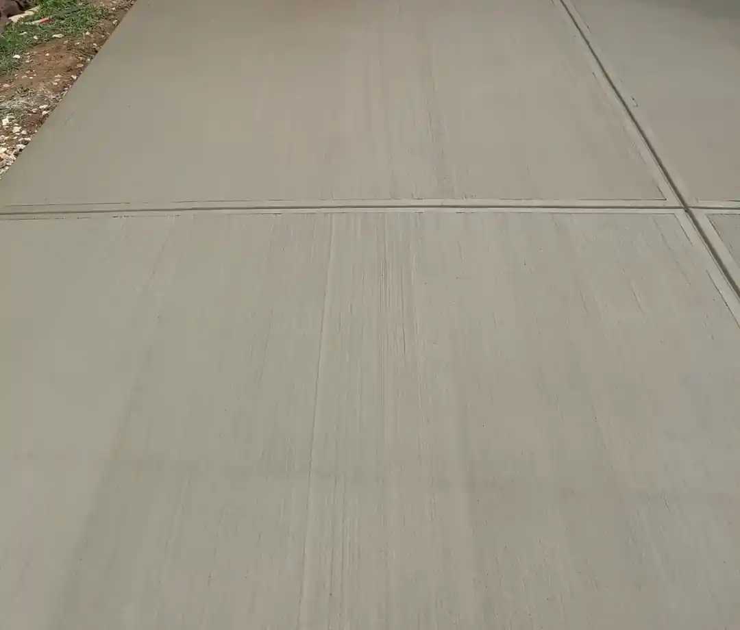 Broom finish and control joints on a backyard concrete patio in Charlotte