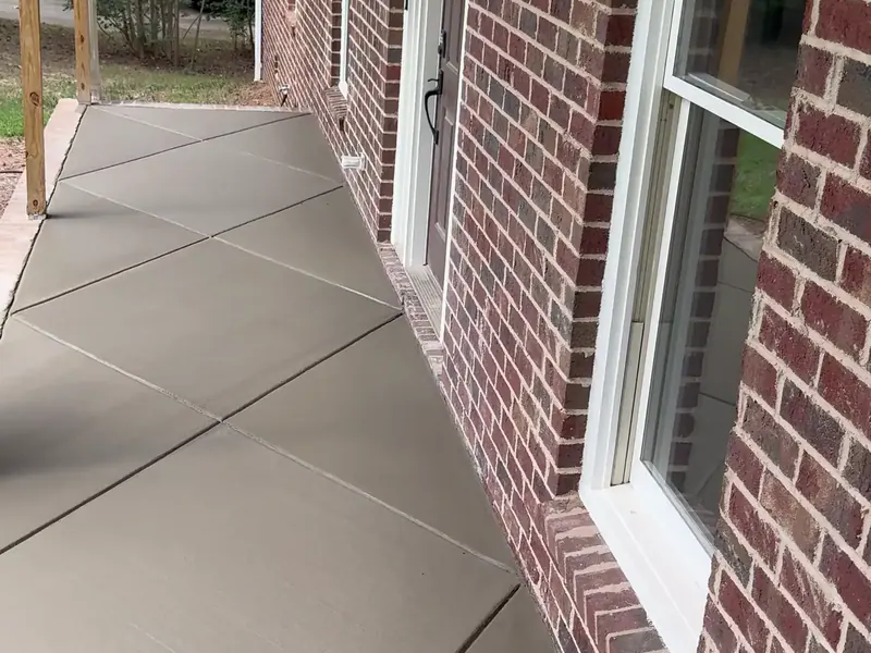 Front porch slab with diagonal joints along a brick house in Charlotte