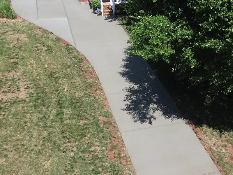 Overhead view of a long curved concrete driveway in Mint Hill