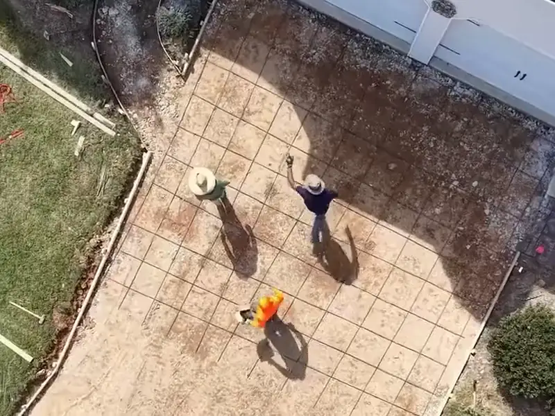 Concrete driveway replacement graded and formed, seen from above with the crew at work