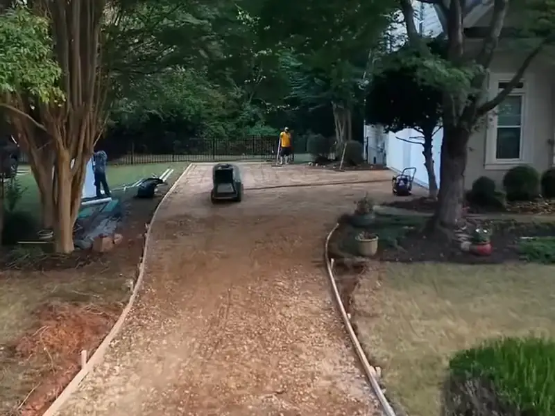 Curved driveway graded and formed under shade trees, ready for new concrete