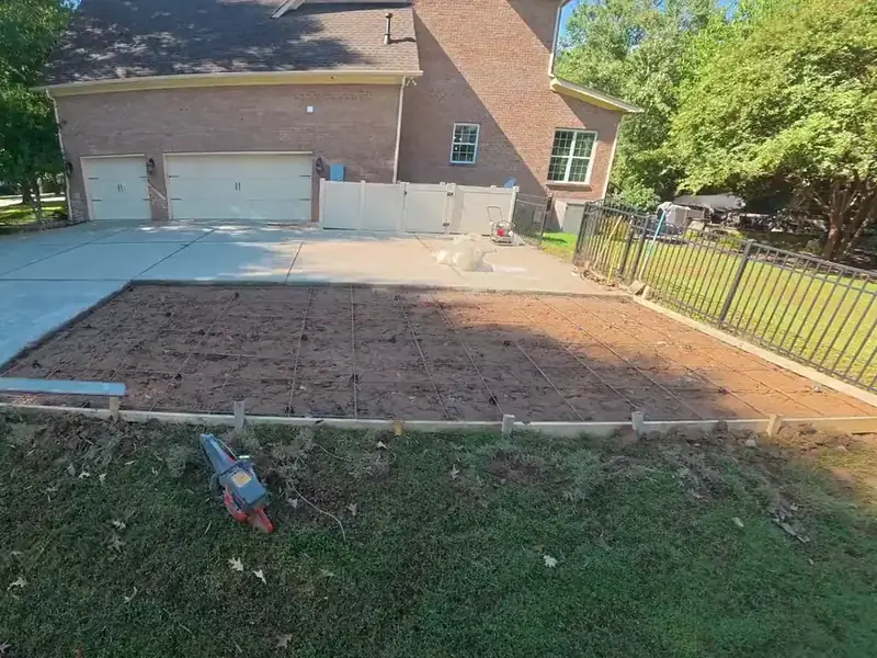Concrete driveway section graded and formed beside the existing slab, ready to pour