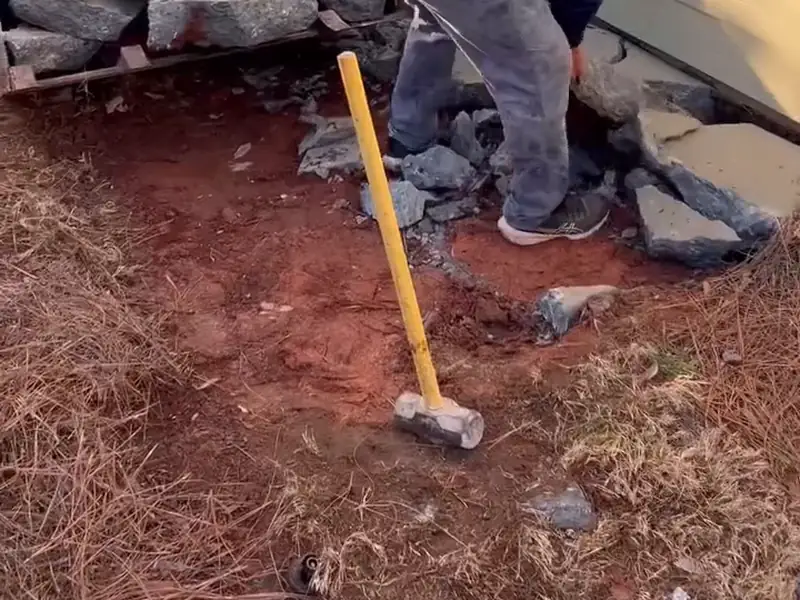 Crew breaking out a damaged concrete patio slab so the section can be replaced